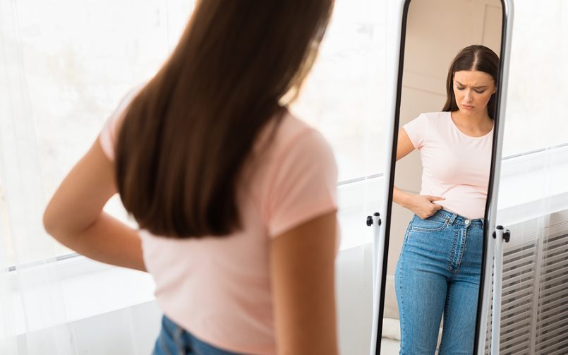 woman gained weight looking in mirror